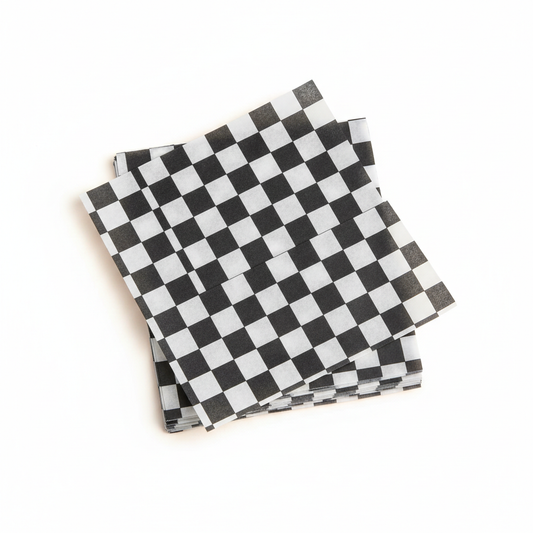 Black and white checkered 12 by 12 inch food paper sheets stacked on a clean white background